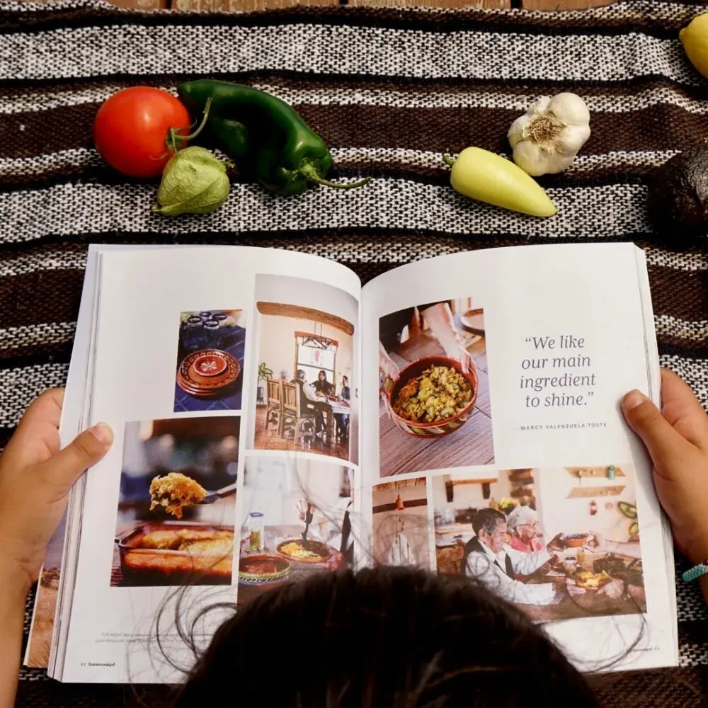 Hands holding an open spread of Homecooked